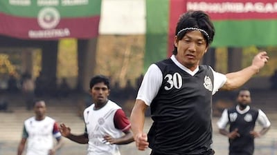 Taro Hasegawa (number 30) of Mohammedan Sporting jumps over Kinshuk Debnath of Mohun Bagan during a match on March 8 in Kolkata, India. Subhendu Ghosh / Getty Images