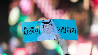 A fan holds up a sign at SM Town Live World Tour VI at the Autism Rocks Arena. Reem Mohammed / The National