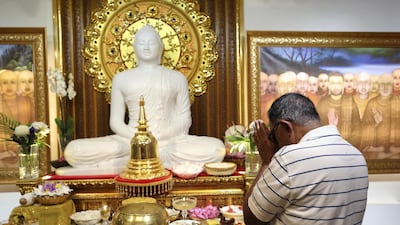 A man worships in Dubai's only Buddhist temple. Chris Whiteoak / The National