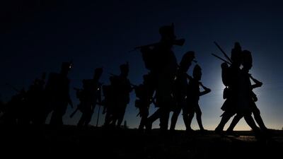 Historical re-enactment enthusiasts dressed as soldiers march to Tvarozna village to take a part of a re-enactment of Napoleon’s famous battle of Austerlitz. Michal Cizek / AFP Photo
