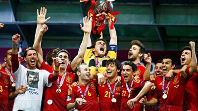 Spain's Iker Casillas lifts up the trophy after defeating Italy to win the Euro 2012 final soccer match at the Olympic stadium in Kiev, July 1, 2012. REUTERS/Kai Pfaffenbach (UKRAINE - Tags: SPORT SOCCER TPX IMAGES OF THE DAY)