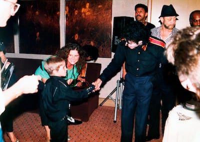 A young Wade Robson shakes hands with pop icon Michael Jackson in 1987, in a scene from 'Leaving Neverland'. HBO via AP)