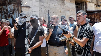 A gunman shoots into the air during the funeral of Palestinians killed during an Israeli raid, in Jenin in the Israeli-occupied West Bank. Reuters