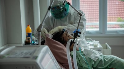 A medical staff treats a Covid-19 patient at a hospital's intensive care unit in Bogor, Indonesia. AFP
