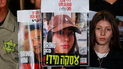 People carry placards with pictures of hostages who were kidnapped during the deadly October 7, 2023 attack, during a protest against the government and to show support for the hostages in Tel Aviv, Israel January 4, 2025. Reuters