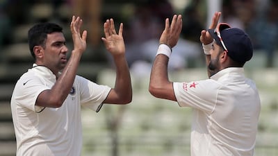 India’s Ravichandran Ashwin, left, celebrates with captain Virat Kohli after the dismissal of Bangladesh’s Shuvagata Hom on the last day of the Test cricket match between them in Fatullah, Bangladesh, Sunday, June 14, 2015. (AP Photo/A.M. Ahad)