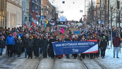 People march through Ludwig-Wucherer-Strasse, Halle, Germany. AP