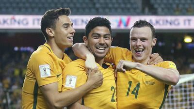 Australia's Christopher Ikonomidis, left, Massimo Luongo, center, and Brad Smith celebrate Luongo's goal during their soccer World Cup qualifying match against Jordan in Sydney, Tuesday, March 29, 2016. (AP Photo/Rick Rycroft)