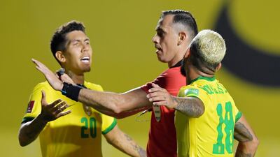 Brazil's Douglas Luiz and Roberto Firmino remonstrate with referee Nelson Almeida. Reuters