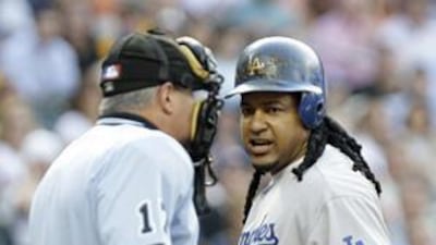 Ramirez argues with the home plate umpire John Hirschbeck after he was called out on strikes.