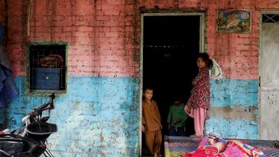 Child refugees from Pakistan stand outside their home at a Hindu refugee settlement in New Delhi. Reuters