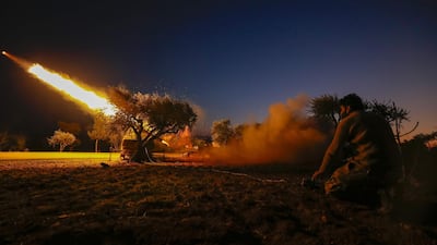 A Syrian rebel fires a rocket towards regime forces positions in the southern countryside of Syria's Aleppo province. AFP