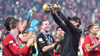 Liverpool manager Jurgen Klopp celebrates with the trophy. EPA