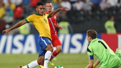 Mosquito, left, attempts to round Russia goalkeeper Anton Mitryushkin. Marwan Naamani / AFP