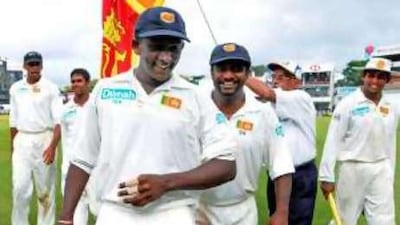 Ajantha Mendis, left, and Muttiah Muralitharan walk off the ground after a job well done.