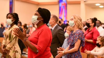 Churchgoers sing along at St Andrew's. Khushnum Bhandari / The National