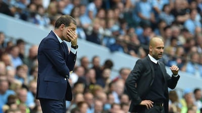 Slaven Bilic, left, and Pep Guardiola look on from the touchline. Jon Super / AFP
