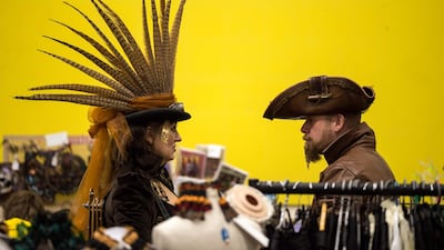 Steampunk enthusiasts peruse the trade stalls in Haworth Village Hall. AFP