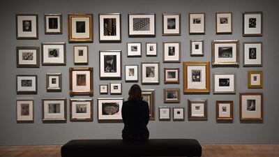 A gallery employee poses in front of photographs belonging to British singer-songwriter Elton John during a press preview for ‘The Radical Eye: Modernist Photography from The Sir Elton John Collection’ at Tate Modern in London. Facundo Arrizabalaga / EPA