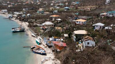Beached boats lie on the shore near damaged houses in Grenada after the passage of Hurricane Beryl this month. Reuters