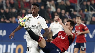 Osasuna defender Unai Garcia, right, vies for the ball with Real Madrid's Brazilian striker Vinicius Jr. EPA