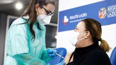 A woman receives a dose of a coronavirus vaccine in Rome. Reuters
