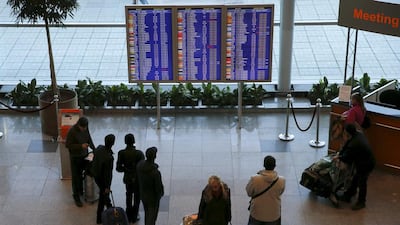 People gather in front of an information board at Domodedovo airport outside Moscow on November 6, 2015. President Vladimir Putin ordered the suspension of all passenger flights to Egypt on Friday until the cause of a deadly plane crash was established. Maxim Zmeyev/Reuters