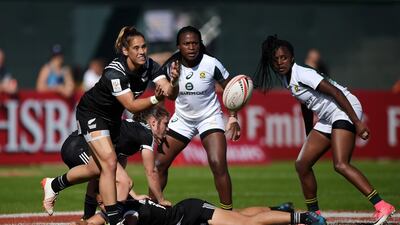 Kayla McAlister, left, of New Zealand passes the ball during the match against South Africa on Day 1 of the Emirates Dubai Rugby Sevens. Tom Dulat / Getty Images