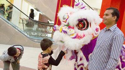 Children enjoying the lion dance at Dragon Mart in Dubai as Chinese around the world usher in the start of the Lunar New Year. Duncan Chard / The National