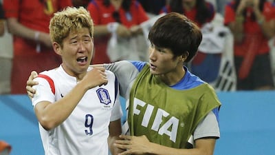 Son Heung-min, left, of South Korea is consoled by teammate Han Kook-young, right, after their elimination from the 2014 World Cup with a 1-0 loss to Belgium on Thursday night in Sao Paulo, Brazil. Lee Jin-man / AP