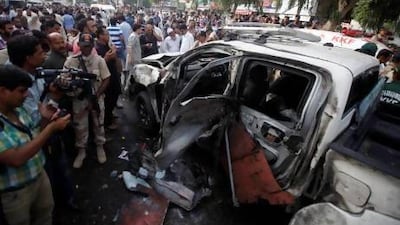 Security personnel and media at the site of a suspected suicide bomb attack in Karachi.