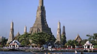 Wat Arun, or Temple of the Dawn, on the bank fo the Chao Phraya River, is a popular tourist attraction that offers visitors a chance to find solace from Bangkok's packed streets.