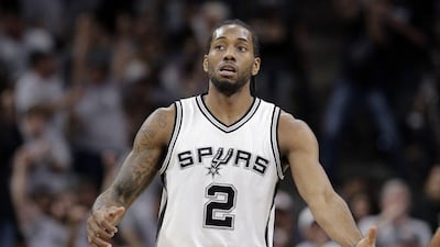 San Antonio Spurs forward Kawhi Leonard (2) reaches out to a teammate after he score against the Oklahoma City Thunder during the first half in Game 1 of a second-round NBA basketball playoff series, Saturday, April 30, 2016, in San Antonio. (AP Photo/Eric Gay)