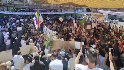 Pro-democracy demonstrators wave Druze and the old Syrian national flags in the southern city of Suweida, on August 16, 2022, at the one year anniversary celebration of the protest movement against President Bashar Al Assad, in the mostly Druze province. Photo: Suhail Thubian.