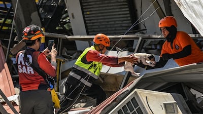 Emergency personnel search for survivors at the site of a collapsed building in General Santos City. AFP