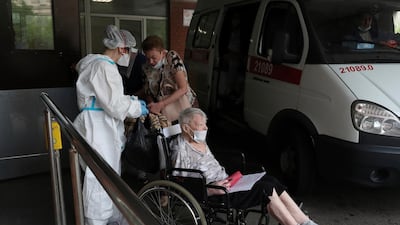 Medical workers transport a patient suspected of having coronavirus at a hospital in St Petersburg, Russia. AP