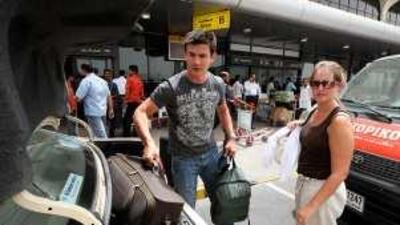 Passengers arriving by taxi at Terminal 1 of Dubai International Airport.