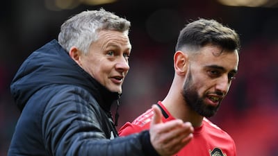 Manchester United's Portuguese midfielder Bruno Fernandes and manager Ole Gunnar Solskjaer. AFP