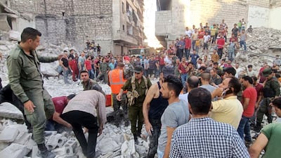Syrian Civil Defense workers and security forces search for victims under the rubble of a destroyed building, in Aleppo, Syria. AP
