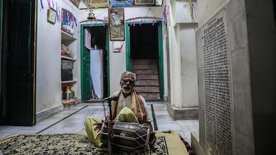 A priest sings devotional songs at the temple at Kashi Labh Mukti Bhawan. EPA