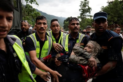 Police officers carry a survivor to a safer place following a flash flood at Trishuli in Nuwakot district, Nepal. Photo: Reuters