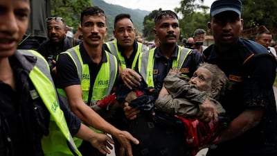 Police officers carry a survivor to a safe place in Trishuli. Reuters