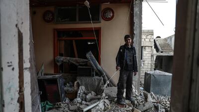 This photo, taken on January 6, 2018, shows a boy standing among the rubble of his destroyed house in the aftermath of air strikes on Mesraba, Eastern Ghouta, which was bombed several times in recent days. Mohammed Badra / EPA