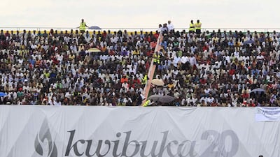 People follow the proceedings of the 20th anniversary commemoration of the Rwandan genocide, in Kigali April 7, 2014. An estimated 800,000 people were killed in 100 days during the genocide. Noor Khamis / Reuters