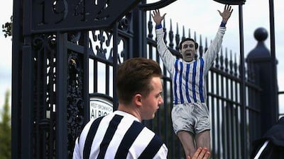 A West Bromwich Albion fan enjoys the pre-match atmosphere before the Premier League against West Ham United. Stephen Pond / Getty Images