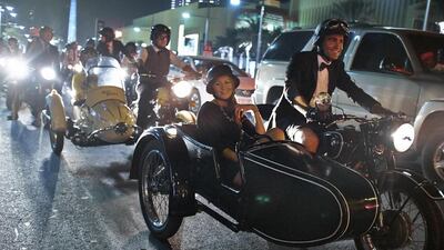 A vintage looking Gentlemen pulls into the road on his Triumph to join fellow riders after a brief stop during the Distinguished Gentleman’s Ride 2014 in Dubai.