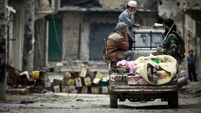 Free Syrian Army fighters cover two dead bodies they found between rubble during heavy clashes with government forces in Aleppo. Narciso Contreras / AP Photo