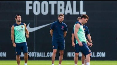 Coach Tito Vilanova, centre, has been overseeing training sessions for his Barcelona players this week in Spain. He will step aside with immediate affect.