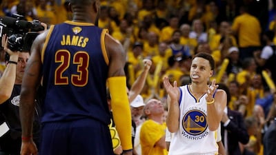 Stephen Curry of the Golden State Warriors celebrates as LeBron James of the Cleveland Cavaliers looks on in the Warriors' 108-100 Game 1 win in the NBA Finals on Thursday. Ezra Shaw / Getty Images / AFP / June 4, 2015