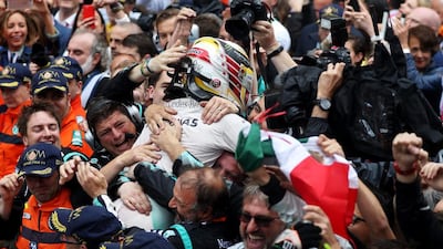 Lewis Hamilton celebrates with his team after winning the Monaco Grand Prix. Lars Baron / Getty Images